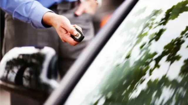 Man with car key