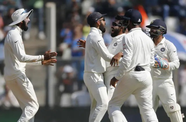 India celebrate the wicket of England captain Alastair Cook