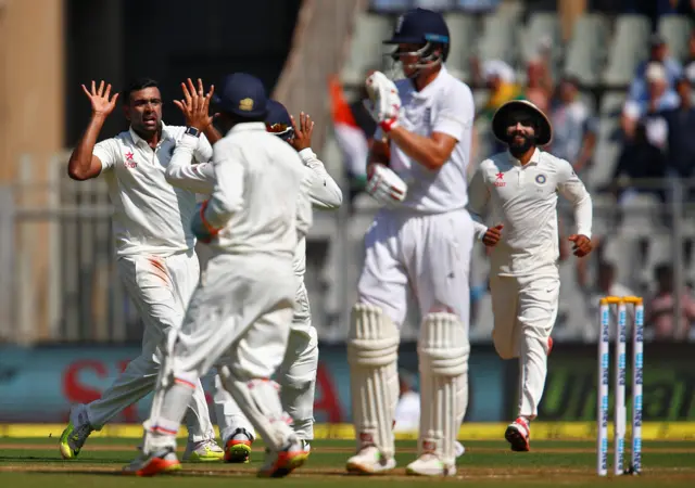 India players celebrate the wicket of England's Joe Root