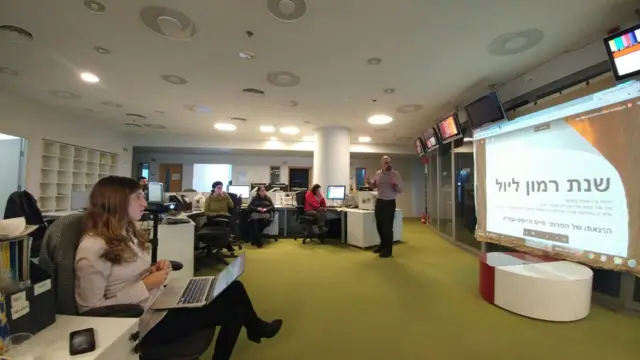 Staff at Jerusalem bureau looking at presentation screen