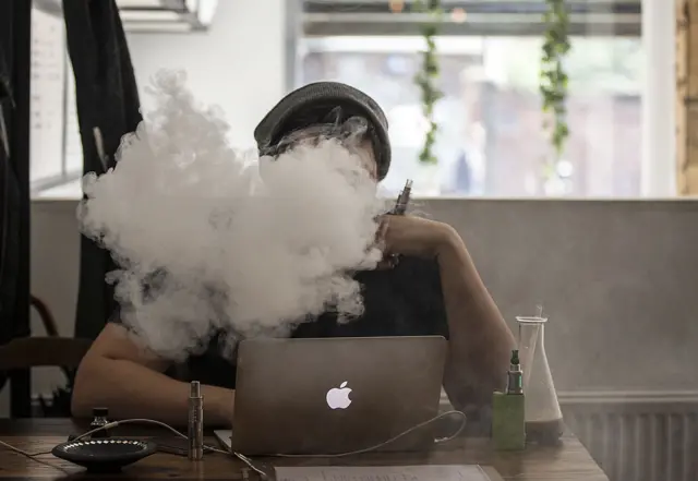 Man smokes an e-cigarette