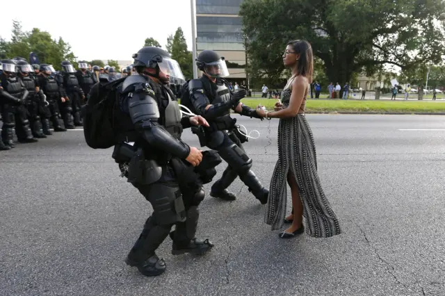 Ieshia Evans is detained by law enforcement officers as she protests the shooting death of Alton Sterling