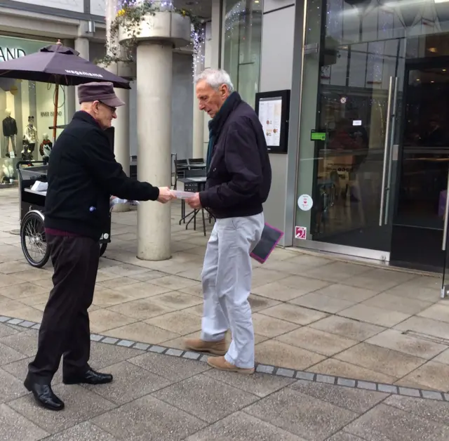 Oliver Mckeague hands out a leaflet in Bury St Edmunds