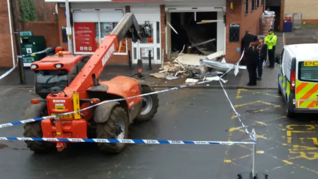 Excavator outside shop