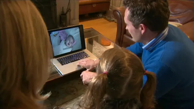 Grace Hall and her parents watching video