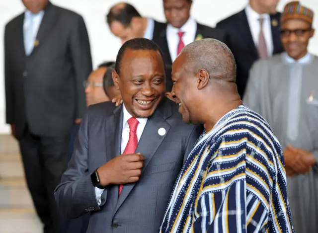 Uhuru Kenyatta (L) smiles as he speaks with John Dramani Mahama prior to the opening session of the 26th presidential summit of the African Union on January 30, 2015 in Addis Ababa