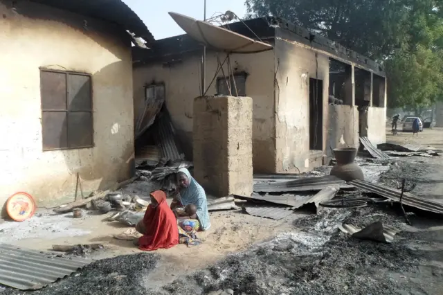 A mother sits mourning the death of her husband after Boko Haram attacks at Dalori village on the outskirts of Maiduguri in northeastern Nigeria on January 31, 2016