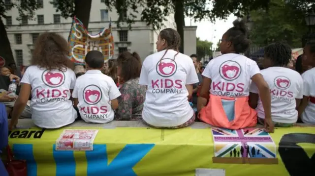 People wearing Kids Company t-shirts