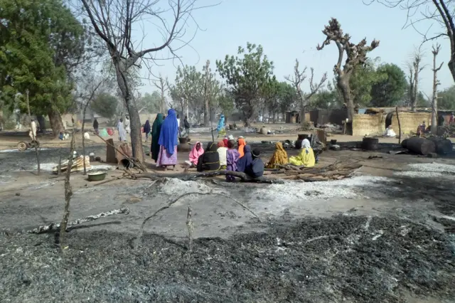 Women and children sit among burnt houses after Boko Haram attacks at Dalori village on the outskirts of Maiduguri in northeastern Nigeria on January 31, 2016