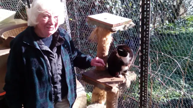 Joyce Harris and one of the cats shes helped