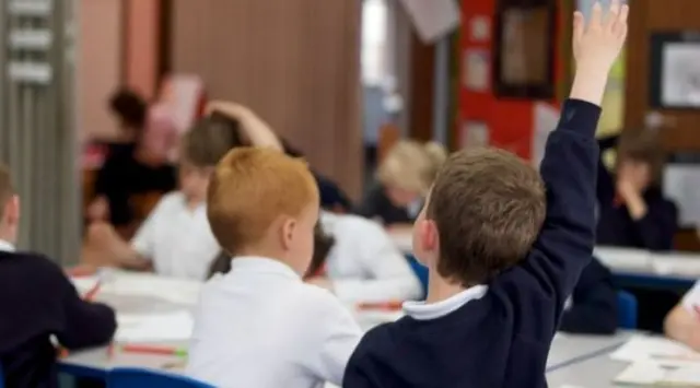 Classroom - pupil with his hand up