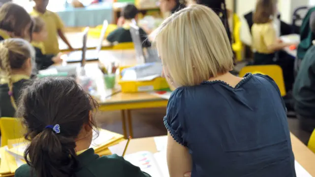 Teacher and child in a classroom