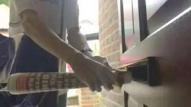 Newspaper being posted through door