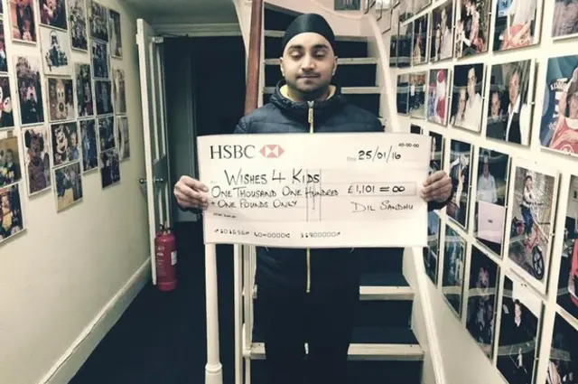 Dil Sandhu and a large cheque