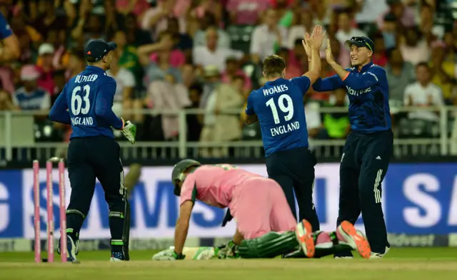 England's players celebrate the run out of AB De Villiers