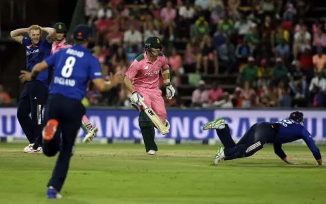 England fielders try to stop the ball