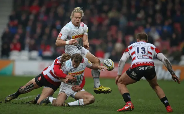 Matt Hopper and Nick Evans of Harlequins lose the ball