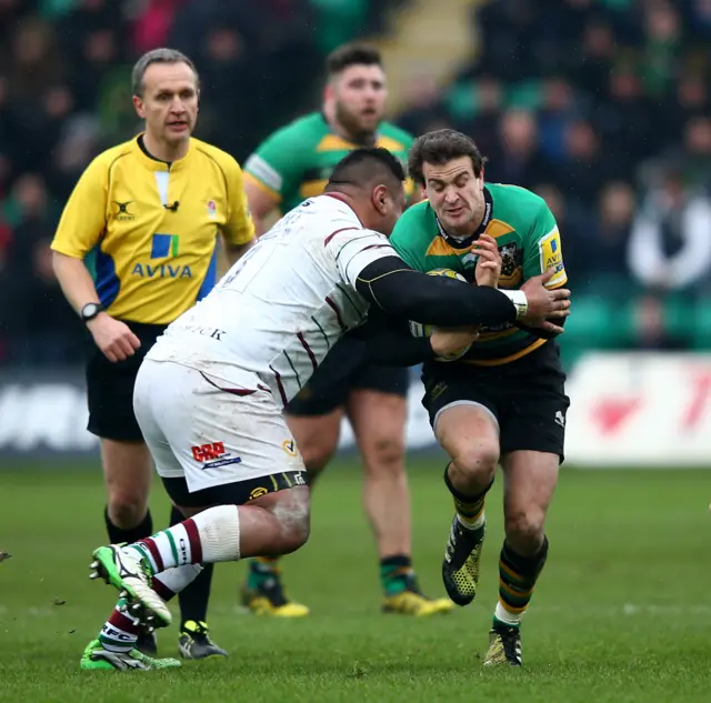 Lee Dickson of Northampton is tackled by Halani Aulika of London Irish