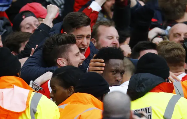 Arsenal players and fans celebrate