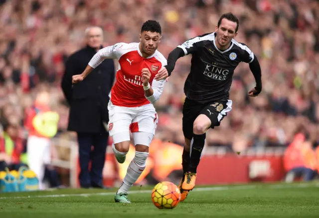 Christian Fuchs in action with Arsenal's Alex Oxlade Chamberlain