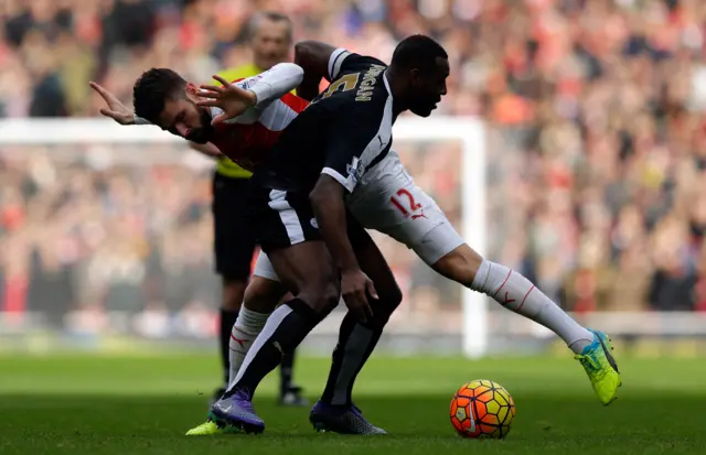 Olivier Giroud fights for the ball with Leicester City's Wes Morgan