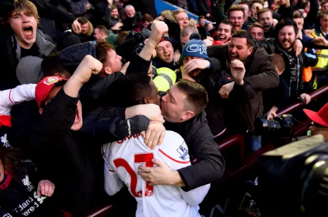 Divock Origi is kissed by a fan