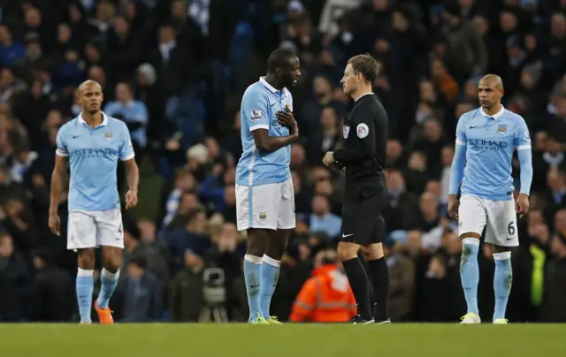 Yaya Toyre talks to referee