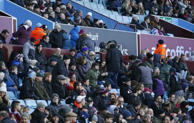 Aston Villa fans leave the stadium