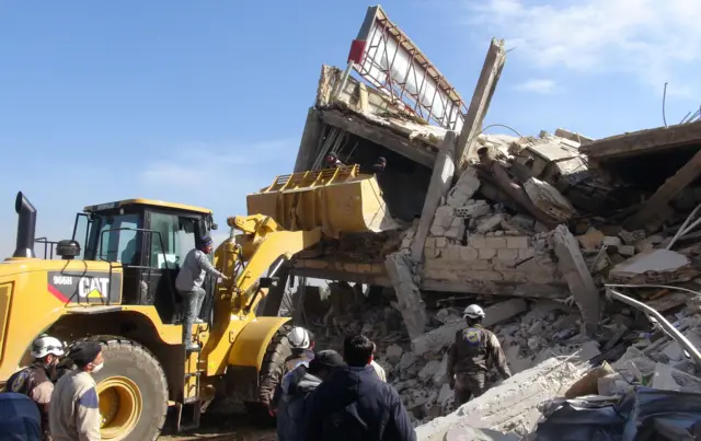 Bulldozer outside damaged hospital in Maarat al-Numan