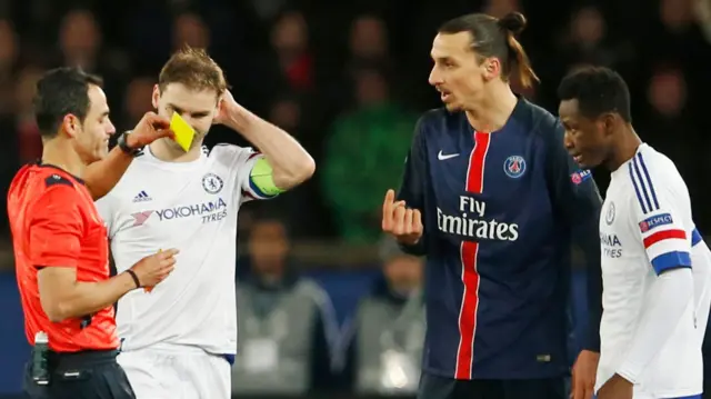 The referee shows a yellow card to Zlatan Ibrahimovic