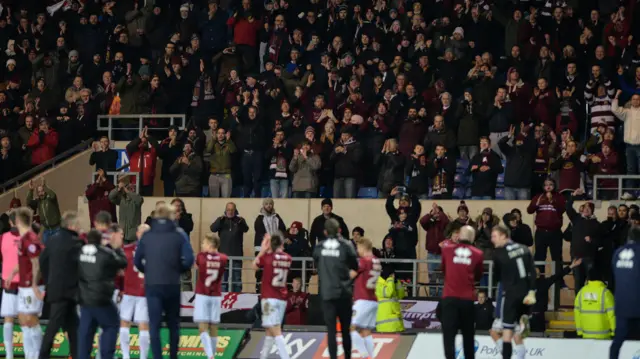 Northampton players celebrate with their fans at Oxford