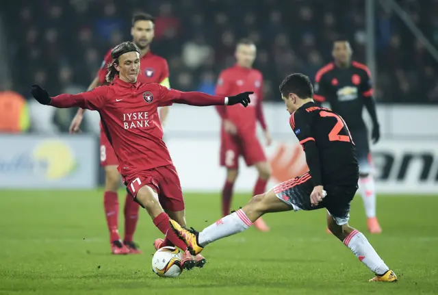 Midtjylland's Kris Olsson is tackled by Ander Herrera