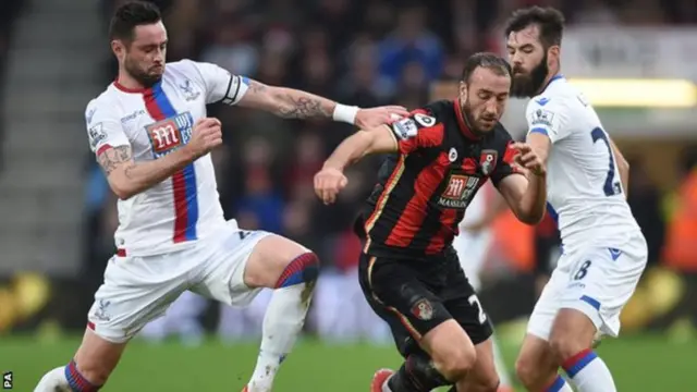 Glenn Murray is challenged by Damien Delaney and Joe Ledley