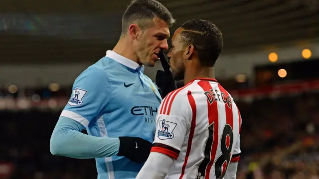 Martin Demichelis and Jermain Defoe clash