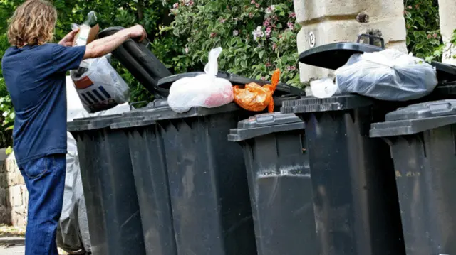 Man putting rubbish in bin