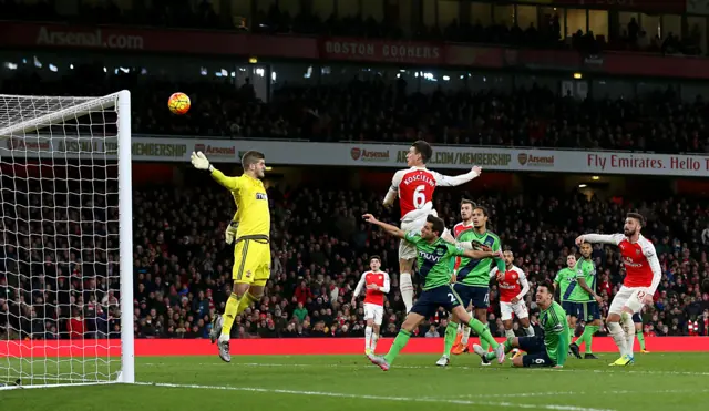 Laurent Koscielny heads towards goal