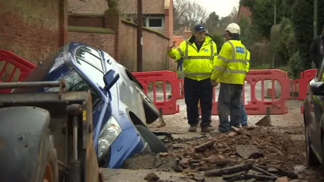 Car in a sink hole