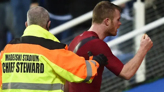 West Brom defender Chris Brunt confronts a fan after having a coin thrown at him