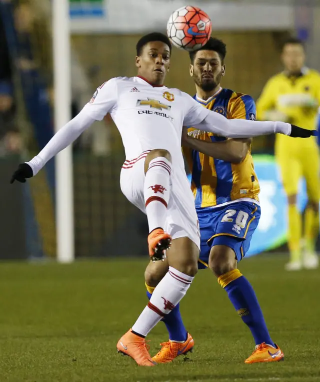 Anthony Martial in action with Shrewsbury Town's Nathaniel Knight-Percival