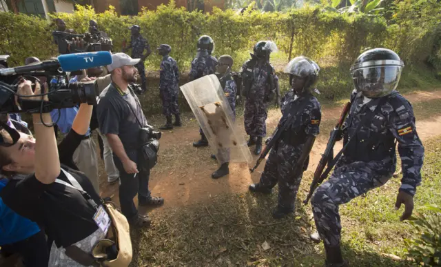 Police shield behind media