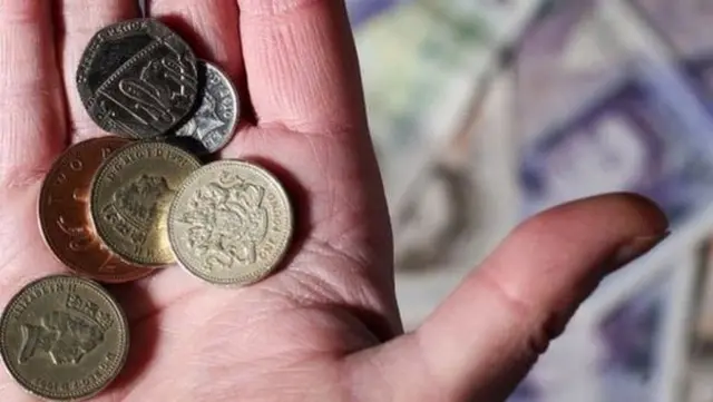 Hand holding GBP coins