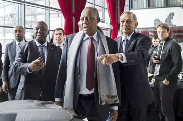 Acting Fifa President Issa Hayatou (C) and Suketu Patel (2-R) arrive for the Confederation of African Football (CAF