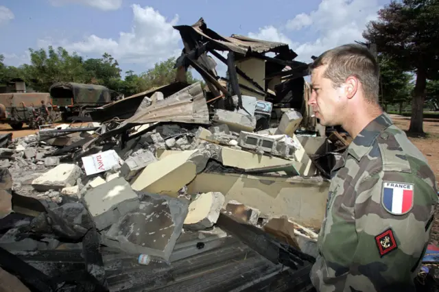 A French soldier amidst the ruins of a French base in Bouake - 2004