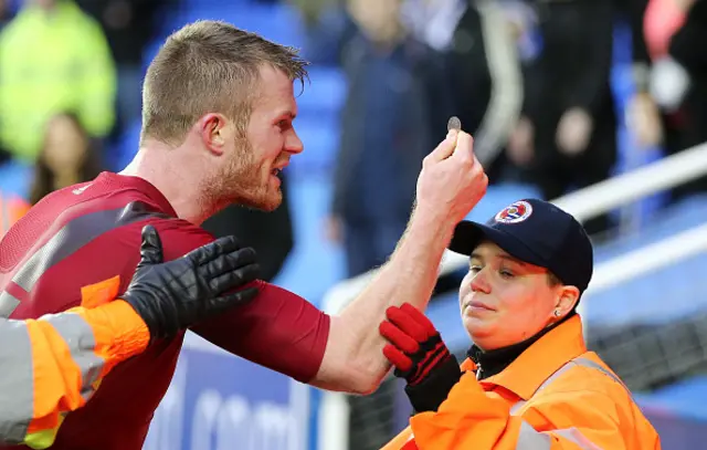 West Brom defender Chris Brunt reacts after being struck by a coin