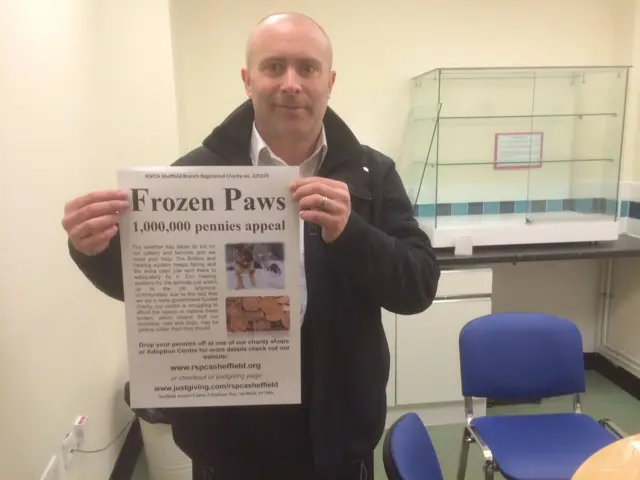 RSPCA employee holding fundraising poster