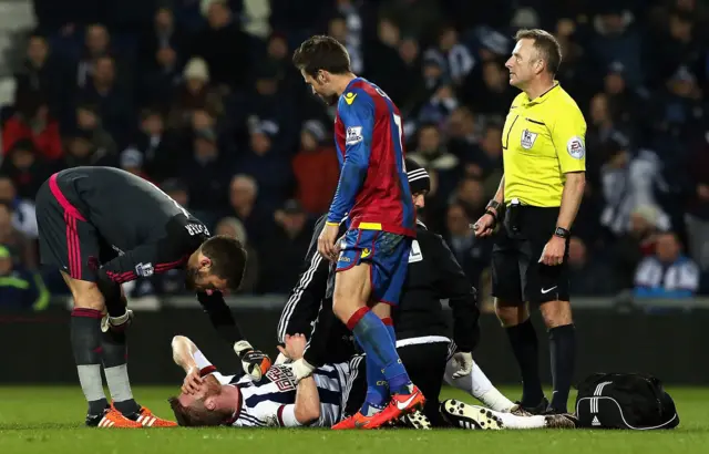 West Brom's Chris Brunt receives medical attention