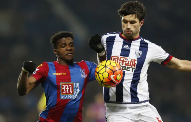 Wilfried Zaha of Palace and Claudio Yacob of West Brom tussle for possession