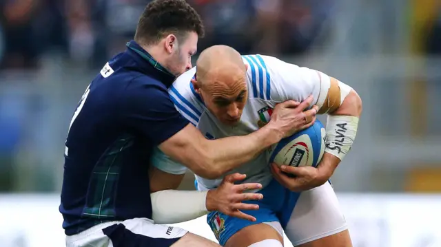 Sergio Parisse of Italy is tackled by Scotland's Duncan Taylor