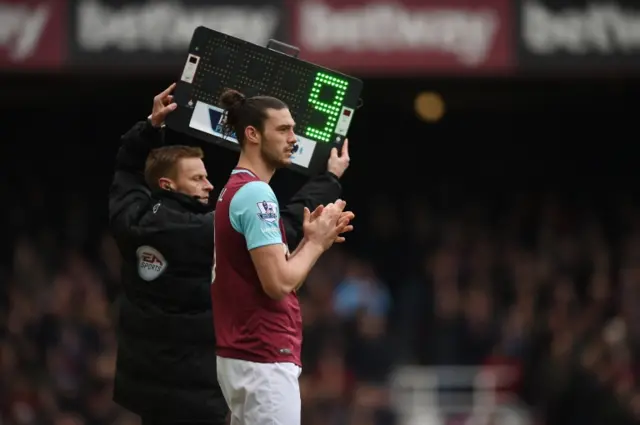 Andy Carroll prepares to come on