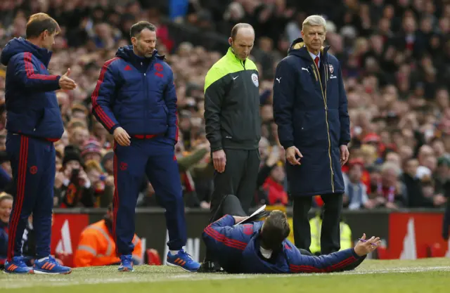 Louis van Gaal lies on the side of the pitch